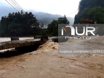 The flood damage is occurring in Gaozhai village, Qiandongnan County, Guizhou province, China, on the morning of June 12, 2024. (