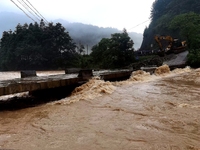 The flood damage is occurring in Gaozhai village, Qiandongnan County, Guizhou province, China, on the morning of June 12, 2024. (