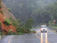 Vehicles are passing through a slope collapse at Sanmatun Road in Liuzhou, China, on June 13, 2024. (