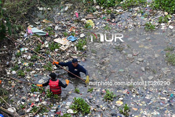 Officers are cleaning up plastic waste that has settled in the Citarum River, Batujajar, Bandung, West Java, Indonesia, on Thursday, June 13...