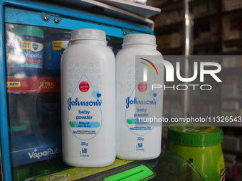 Bottles of Johnson & Johnson baby powder are being displayed at a drugstore in Srinagar, India, on June 13, 2024. Johnson & Johnson is agree...