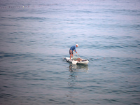 Palestinian fishermen are sailing on a boat in Deir el-Balah, in the central Gaza Strip, on June 13, 2024, amid the ongoing conflict in the...