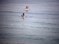 Palestinian fishermen are sailing on a boat in Deir el-Balah, in the central Gaza Strip, on June 13, 2024, amid the ongoing conflict in the...