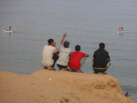 Palestinian fishermen are sailing on a boat in Deir el-Balah, in the central Gaza Strip, on June 13, 2024, amid the ongoing conflict in the...