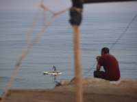 Palestinian fishermen are sailing on a boat in Deir el-Balah, in the central Gaza Strip, on June 13, 2024, amid the ongoing conflict in the...