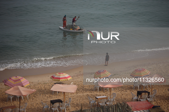 Palestinian fishermen are sailing on a boat in Deir el-Balah, in the central Gaza Strip, on June 13, 2024, amid the ongoing conflict in the...