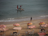 Palestinian fishermen are sailing on a boat in Deir el-Balah, in the central Gaza Strip, on June 13, 2024, amid the ongoing conflict in the...