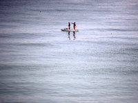 Palestinian fishermen are sailing on a boat in Deir el-Balah, in the central Gaza Strip, on June 13, 2024, amid the ongoing conflict in the...