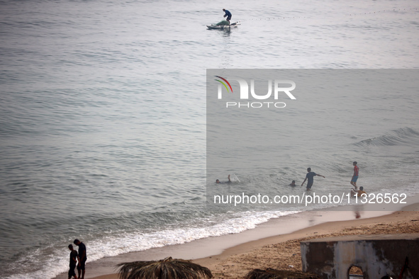 Palestinian fishermen are sailing on a boat in Deir el-Balah, in the central Gaza Strip, on June 13, 2024, amid the ongoing conflict in the...