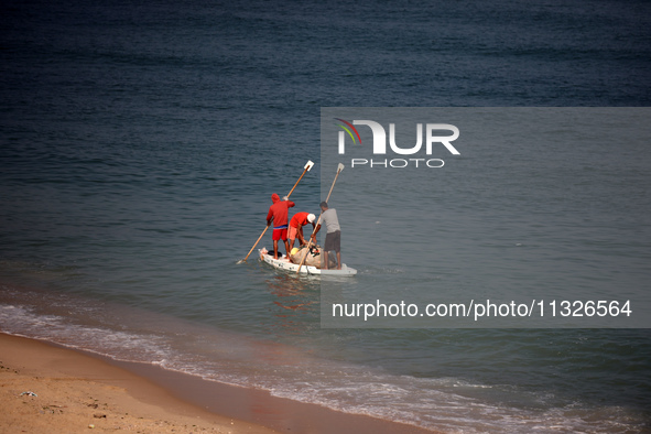 Palestinian fishermen are sailing on a boat in Deir el-Balah, in the central Gaza Strip, on June 13, 2024, amid the ongoing conflict in the...