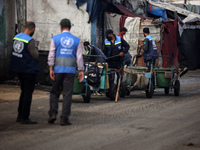 United Nations Agency for Palestinian Refugees (UNRWA) workers are cleaning a street in Deir el-Balah, in the central Gaza Strip, on June 13...