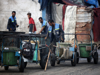 United Nations Agency for Palestinian Refugees (UNRWA) workers are cleaning a street in Deir el-Balah, in the central Gaza Strip, on June 13...