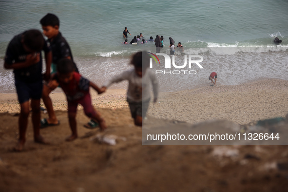 Displaced Palestinians are enjoying swimming in Deir el-Balah, in the central Gaza Strip, on June 13, 2024, amid the ongoing conflict in the...