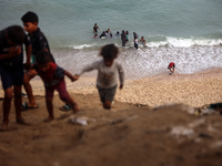 Displaced Palestinians are enjoying swimming in Deir el-Balah, in the central Gaza Strip, on June 13, 2024, amid the ongoing conflict in the...