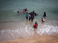 Displaced Palestinians are enjoying swimming in Deir el-Balah, in the central Gaza Strip, on June 13, 2024, amid the ongoing conflict in the...