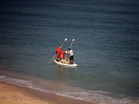 Palestinian fishermen are sailing on a boat in Deir el-Balah, in the central Gaza Strip, on June 13, 2024, amid the ongoing conflict in the...