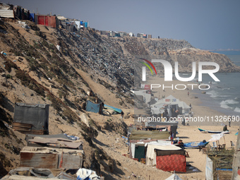 Displaced Palestinians are enjoying in Deir el-Balah, in the central Gaza Strip, on June 13, 2024, amid the ongoing conflict in the Palestin...