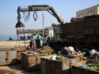 United Nations Agency for Palestinian Refugees (UNRWA) workers are cleaning a street in Deir el-Balah, in the central Gaza Strip, on June 13...