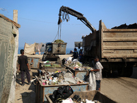 United Nations Agency for Palestinian Refugees (UNRWA) workers are cleaning a street in Deir el-Balah, in the central Gaza Strip, on June 13...