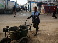 United Nations Agency for Palestinian Refugees (UNRWA) workers are cleaning a street in Deir el-Balah, in the central Gaza Strip, on June 13...