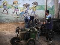 United Nations Agency for Palestinian Refugees (UNRWA) workers are cleaning a street in Deir el-Balah, in the central Gaza Strip, on June 13...