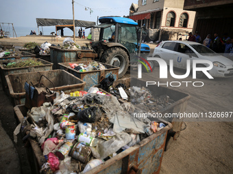 United Nations Agency for Palestinian Refugees (UNRWA) workers are cleaning a street in Deir el-Balah, in the central Gaza Strip, on June 13...