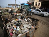 United Nations Agency for Palestinian Refugees (UNRWA) workers are cleaning a street in Deir el-Balah, in the central Gaza Strip, on June 13...