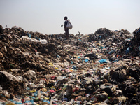 A Palestinian boy is searching for recyclables at a garbage dump in Deir el-Balah, in the central Gaza Strip, on June 13, 2024, amid the ong...