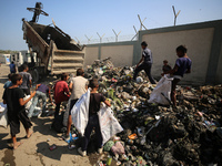 Displaced Palestinian children are searching for recyclables at a garbage dump in Deir el-Balah, in the central Gaza Strip, on June 13, 2024...