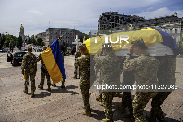 Servicemen are carrying the coffin of Captain Arsen Fedosenko, a photographer for the Media Center of the Ukrainian Armed Forces Strategic C...