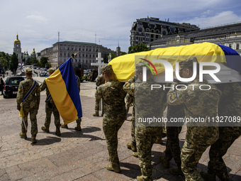 Servicemen are carrying the coffin of Captain Arsen Fedosenko, a photographer for the Media Center of the Ukrainian Armed Forces Strategic C...