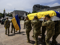 Servicemen are carrying the coffin of Captain Arsen Fedosenko, a photographer for the Media Center of the Ukrainian Armed Forces Strategic C...