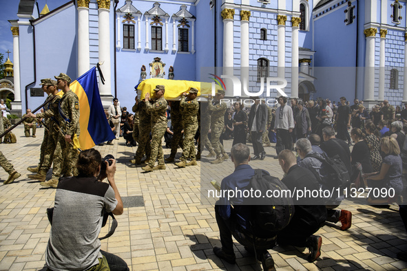 Servicemen are carrying the coffin of Captain Arsen Fedosenko, a photographer for the Media Center of the Ukrainian Armed Forces Strategic C...