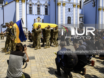 Servicemen are carrying the coffin of Captain Arsen Fedosenko, a photographer for the Media Center of the Ukrainian Armed Forces Strategic C...