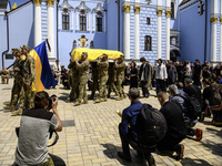 Servicemen are carrying the coffin of Captain Arsen Fedosenko, a photographer for the Media Center of the Ukrainian Armed Forces Strategic C...