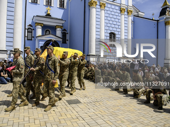 People are attending a funeral service for Captain Arsen Fedosenko, a photographer for the Media Center of the Ukrainian Armed Forces Strate...