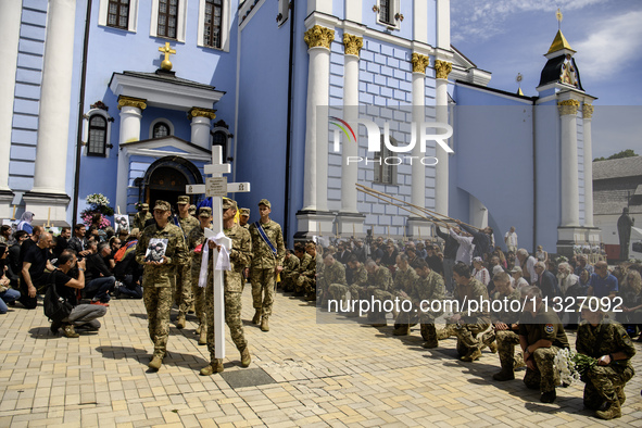 People are attending a funeral service for Captain Arsen Fedosenko, a photographer for the Media Center of the Ukrainian Armed Forces Strate...