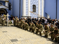 People are attending a funeral service for Captain Arsen Fedosenko, a photographer for the Media Center of the Ukrainian Armed Forces Strate...