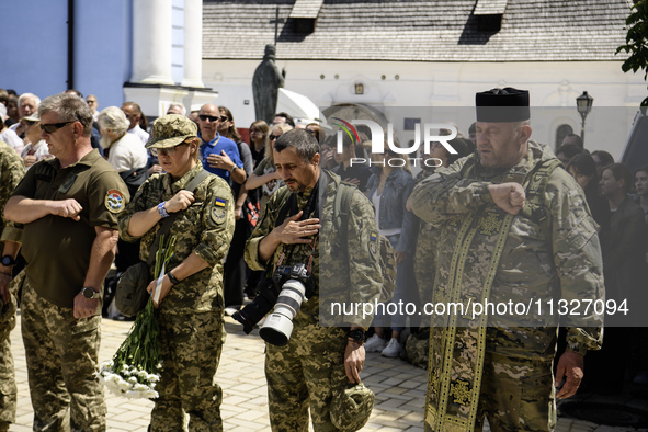 Servicemen are attending a funeral service for Captain Arsen Fedosenko, a photographer for the Media Center of the Ukrainian Armed Forces St...