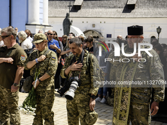 Servicemen are attending a funeral service for Captain Arsen Fedosenko, a photographer for the Media Center of the Ukrainian Armed Forces St...