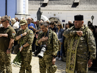 Servicemen are attending a funeral service for Captain Arsen Fedosenko, a photographer for the Media Center of the Ukrainian Armed Forces St...