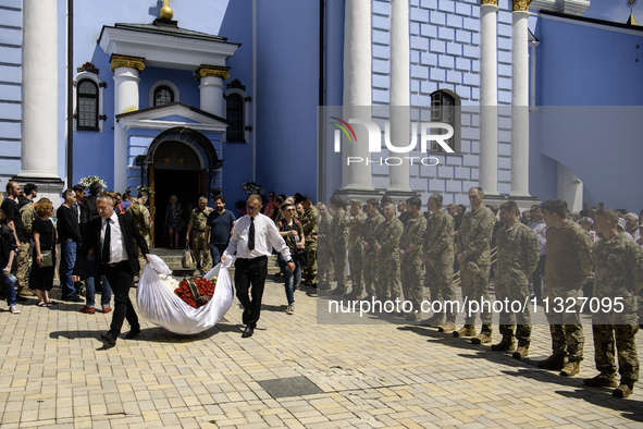 People are attending a funeral service for Captain Arsen Fedosenko, a photographer for the Media Center of the Ukrainian Armed Forces Strate...