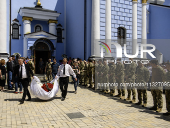 People are attending a funeral service for Captain Arsen Fedosenko, a photographer for the Media Center of the Ukrainian Armed Forces Strate...