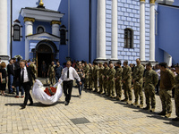 People are attending a funeral service for Captain Arsen Fedosenko, a photographer for the Media Center of the Ukrainian Armed Forces Strate...