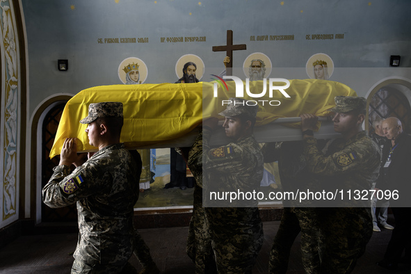 Servicemen are carrying the coffin of Captain Arsen Fedosenko, a photographer for the Media Center of the Ukrainian Armed Forces Strategic C...