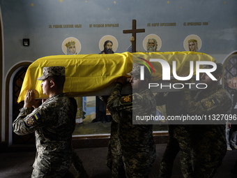 Servicemen are carrying the coffin of Captain Arsen Fedosenko, a photographer for the Media Center of the Ukrainian Armed Forces Strategic C...