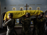 Servicemen are carrying the coffin of Captain Arsen Fedosenko, a photographer for the Media Center of the Ukrainian Armed Forces Strategic C...