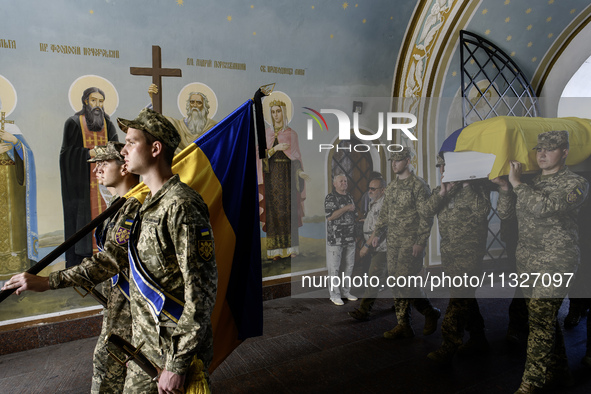 Servicemen are carrying the coffin of Captain Arsen Fedosenko, a photographer for the Media Center of the Ukrainian Armed Forces Strategic C...