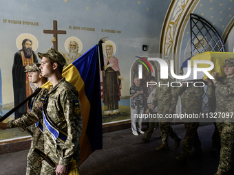 Servicemen are carrying the coffin of Captain Arsen Fedosenko, a photographer for the Media Center of the Ukrainian Armed Forces Strategic C...