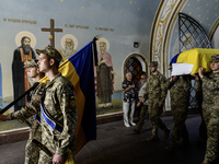 Servicemen are carrying the coffin of Captain Arsen Fedosenko, a photographer for the Media Center of the Ukrainian Armed Forces Strategic C...